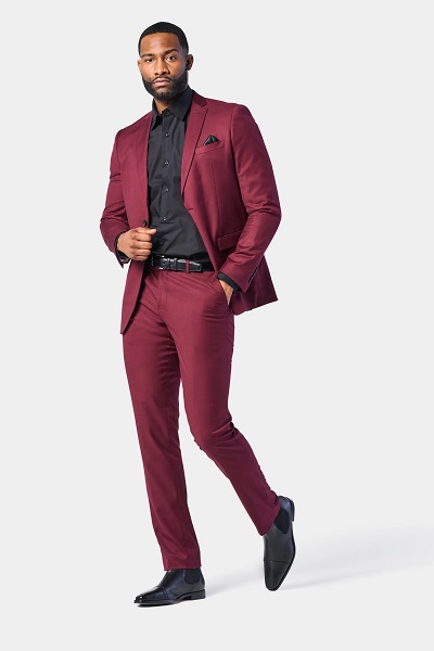 man wearing burgundy 2 piece suit with a black shirt underneath