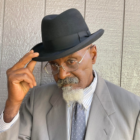 Gentleman wearing a black homburg hat from Contempo