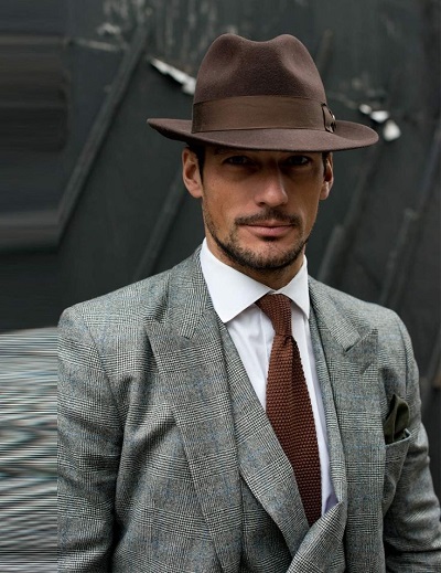 confident man wearing a mens fedora dress hat from Contempo Suits.